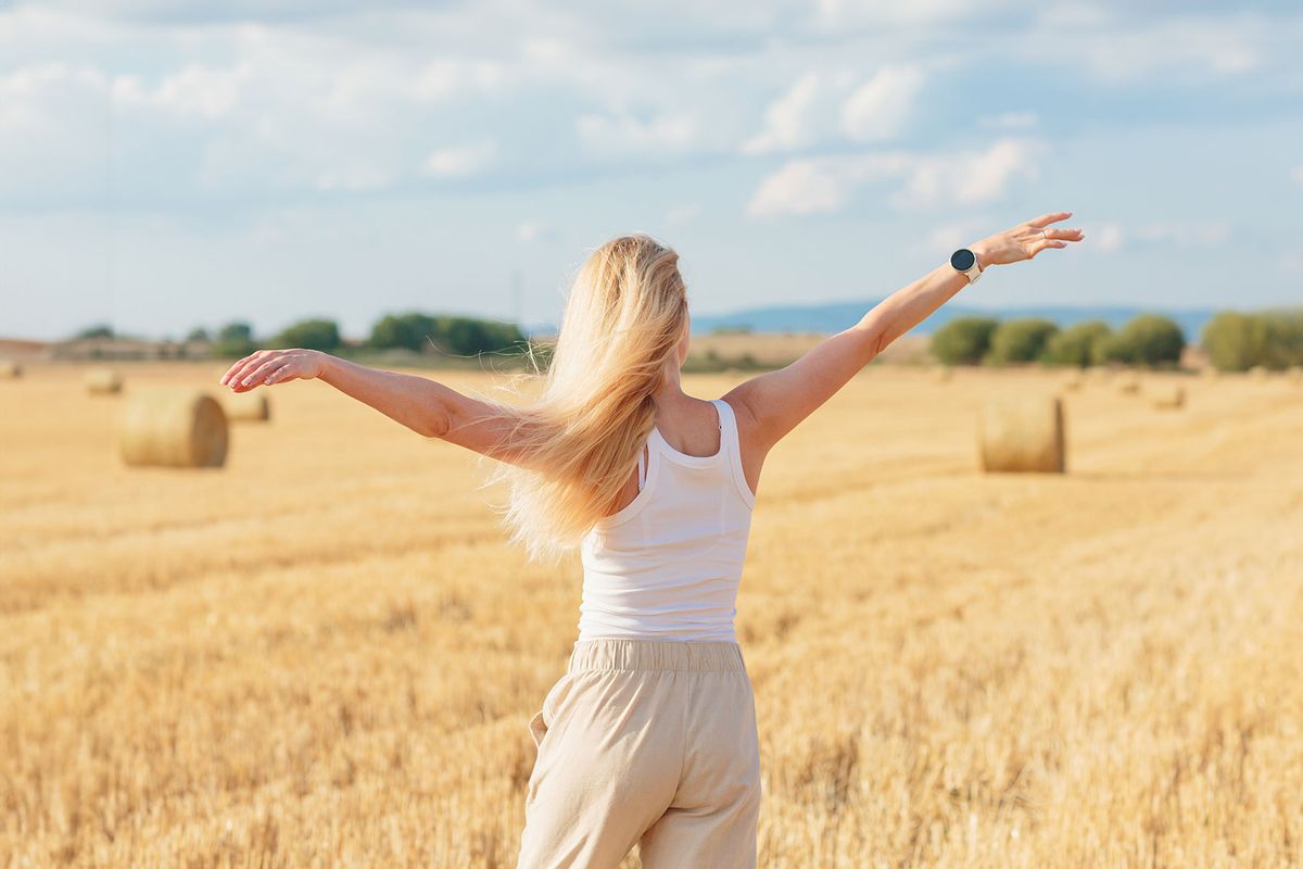 Blonde woman dancing in a wheat field (Getty Images/Svittlana Kuchina)