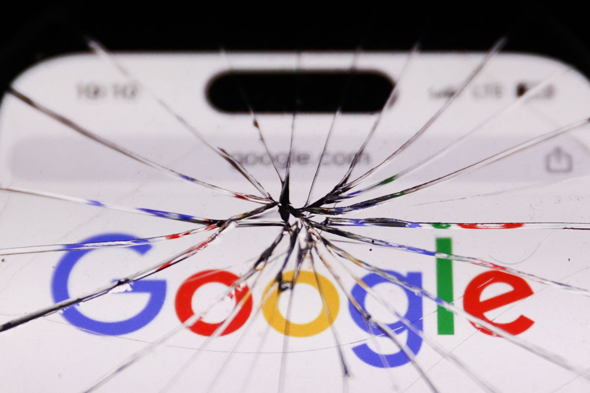 Google logo on website displayed on a phone screen is seen through the broken glass. (Jakub Porzycki/NurPhoto via Getty Images)