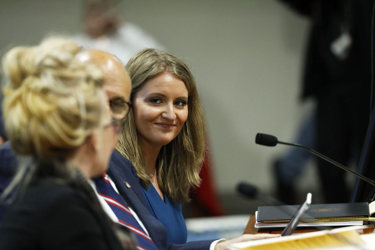 Lawyer Jenna Ellis (R) listens to Melissa Carone, who was working for Dominion Voting Services, as she speaks in front of the Michigan House Oversight Committee in Lansing, Michigan on December 2, 2020. (JEFF KOWALSKY/AFP via Getty Images)