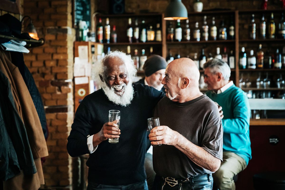 A couple of old friends catching up over a drink at a craft beer bar together (Getty Images/Hinterhaus Productions)