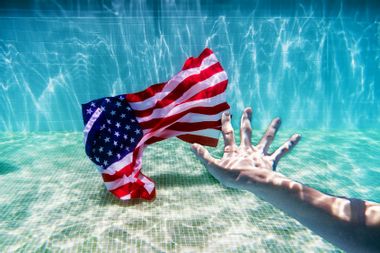 Reaching for underwater American flag