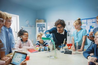 Science Teacher Shows Chemical Reaction Experiment To Children